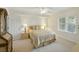 Neutral bedroom with a decorative bed, side table, and a bright window at 426 Bouchelle Dr # 202, New Smyrna Beach, FL 32169