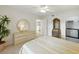 Well-lit bedroom with a dresser, round mirror, and view to the kitchen at 426 Bouchelle Dr # 202, New Smyrna Beach, FL 32169
