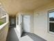 Condo entrance featuring an open door, neutral paint, and exterior lighting at 426 Bouchelle Dr # 202, New Smyrna Beach, FL 32169
