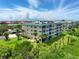 A condo building with well-maintained lawns and towering palm trees, offering scenic views and a serene coastal living experience at 426 Bouchelle Dr # 202, New Smyrna Beach, FL 32169