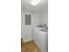 Well-lit laundry room with washer, dryer, and nearby electrical panel for easy maintenance at 426 Bouchelle Dr # 202, New Smyrna Beach, FL 32169