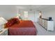 Spacious bedroom featuring a plush bed, a large dresser, and ample natural light from nearby windows at 426 Bouchelle Dr # 202, New Smyrna Beach, FL 32169