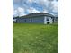 Expansive backyard featuring lush green grass and a well-maintained exterior at 483 Shadow Gorge Way, Eustis, FL 32736