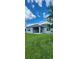 Spacious backyard with lush green grass and a covered patio, perfect for outdoor living at 483 Shadow Gorge Way, Eustis, FL 32736