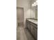 Bathroom with double sinks, granite countertops, and tiled flooring at 483 Shadow Gorge Way, Eustis, FL 32736