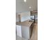 Granite kitchen island with stainless steel sink, storage cabinets, and modern fixtures at 483 Shadow Gorge Way, Eustis, FL 32736