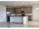 Bright, open kitchen featuring a spacious island and stainless steel appliances at 483 Shadow Gorge Way, Eustis, FL 32736