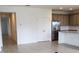 Kitchen showcasing a large island, granite counters, and modern stainless steel refrigerator at 483 Shadow Gorge Way, Eustis, FL 32736