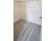 Walk-in closet with neutral carpeting and wire shelving for organized storage solutions at 483 Shadow Gorge Way, Eustis, FL 32736