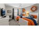 Comfortable bedroom featuring two twin beds, a ceiling fan, and nautical-themed decor that enhances the ambiance at 4895 Clock Tower Dr, Kissimmee, FL 34746