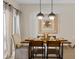 Inviting dining area featuring pendant lights, modern decor, and neutral walls with easy access to outdoor seating at 4895 Clock Tower Dr, Kissimmee, FL 34746