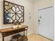 Inviting entryway shows neutral decor, a decorative mirror, and a glimpse of the home's security system at 4895 Clock Tower Dr, Kissimmee, FL 34746