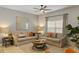 Comfortable living room featuring cozy seating, neutral tones, stylish decor, and a large window at 4895 Clock Tower Dr, Kissimmee, FL 34746
