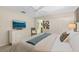 Bright main bedroom features a TV, a ceiling fan, and an ensuite door that enhances convenience at 4895 Clock Tower Dr, Kissimmee, FL 34746
