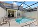Screened-in pool area with a beautiful pool perfect for relaxation and entertaining at 4895 Clock Tower Dr, Kissimmee, FL 34746