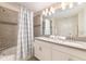 Beautiful bathroom with double sinks, quartz countertops, and tiled shower/tub at 5025 Windermere Ave, Kissimmee, FL 34746