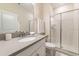 Well-lit bathroom featuring a modern vanity with quartz countertop and a glass-enclosed shower at 5025 Windermere Ave, Kissimmee, FL 34746