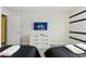 The bedroom offers two twin beds, white dresser, and a TV screen at 5025 Windermere Ave, Kissimmee, FL 34746