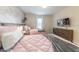Welcoming bedroom with brick accent wall, two twin beds, and television at 5025 Windermere Ave, Kissimmee, FL 34746