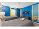 The bedroom includes two beds with colorful Minions decor and a TV screen at 5025 Windermere Ave, Kissimmee, FL 34746