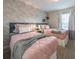 Charming bedroom with light brick accent wall, two twin beds, and soft pink bedding at 5025 Windermere Ave, Kissimmee, FL 34746