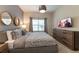Comfortable bedroom featuring stylish decor, warm lighting, and a TV, offering a relaxing atmosphere at 5025 Windermere Ave, Kissimmee, FL 34746