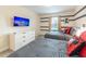 Bedroom featuring striped walls, custom Disney decor, twin beds, and television at 5025 Windermere Ave, Kissimmee, FL 34746