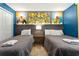 Comfortable bedroom features two twin beds with playful Minions decor and colorful blue walls at 5025 Windermere Ave, Kissimmee, FL 34746