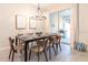 Cozy dining area showcasing a modern chandelier, seating for six, and easy access to the outdoors at 5025 Windermere Ave, Kissimmee, FL 34746