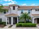 Charming townhome with a tile roof, covered porch, and beautifully maintained landscaping at 5025 Windermere Ave, Kissimmee, FL 34746