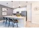 Modern kitchen with island, quartz countertops, stainless steel appliances, and stylish pendant lighting at 5025 Windermere Ave, Kissimmee, FL 34746