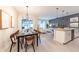 Open concept living area showcasing modern décor, dining set, and seamless flow to the outdoors at 5025 Windermere Ave, Kissimmee, FL 34746