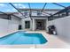 Screened-in pool area featuring a barbecue grill and outdoor seating at 5025 Windermere Ave, Kissimmee, FL 34746