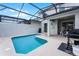 Inviting screened-in pool area that includes outdoor dining at 5025 Windermere Ave, Kissimmee, FL 34746