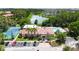Community clubhouse, pool, and tennis court with green landscaping and pond views at 5160 Conroy Rd # 21, Orlando, FL 32811