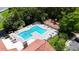 Aerial view of a community pool, playground, lounge chairs, and green landscaping at 5160 Conroy Rd # 21, Orlando, FL 32811