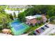 Aerial shot showcasing the clubhouse, pool, tennis court, parking, and surrounding landscape at 5160 Conroy Rd # 21, Orlando, FL 32811