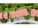 Aerial view of a red-roofed condo building surrounded by lush greenery and parking at 5160 Conroy Rd # 21, Orlando, FL 32811