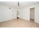 Bright bedroom featuring wood-look floors, track lighting, and closet access at 5160 Conroy Rd # 21, Orlando, FL 32811