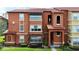 Attractive multi-story condo with red tile roof, well-maintained landscaping and stucco exterior at 5160 Conroy Rd # 21, Orlando, FL 32811