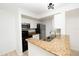 Functional kitchen featuring white cabinets, granite countertops, stainless steel appliances, and a convenient breakfast bar at 5160 Conroy Rd # 21, Orlando, FL 32811