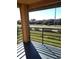 Balcony featuring railings with views of a green lawn, street, and neighborhood buildings at 5220 Via Hacienda # 212, Orlando, FL 32839