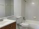 Well-lit bathroom with a tub/shower combination, single sink vanity, and tiled walls at 5220 Via Hacienda # 212, Orlando, FL 32839
