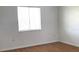 Comfortable bedroom with light hardwood floors, natural light, and clean design at 5220 Via Hacienda # 212, Orlando, FL 32839