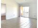 Bright, open living space with tile flooring and a sliding glass door to the balcony at 5220 Via Hacienda # 212, Orlando, FL 32839