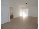 Open living area with tile floors, neutral paint and a sliding door to let in plenty of light at 5220 Via Hacienda # 212, Orlando, FL 32839