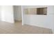 Cozy open space featuring tile flooring, neutral walls, and a pass-through to the kitchen at 5220 Via Hacienda # 212, Orlando, FL 32839