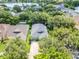 Aerial view of a single-Gathering home showing the driveway and mature trees at 5263 Beach River Road, Windermere, FL 34786