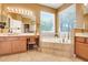 Bright bathroom showcasing a garden tub, double vanity, and serene natural light at 5263 Beach River Road, Windermere, FL 34786