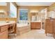 Bright bathroom showcasing a garden tub, double vanity, and glass-enclosed shower at 5263 Beach River Road, Windermere, FL 34786